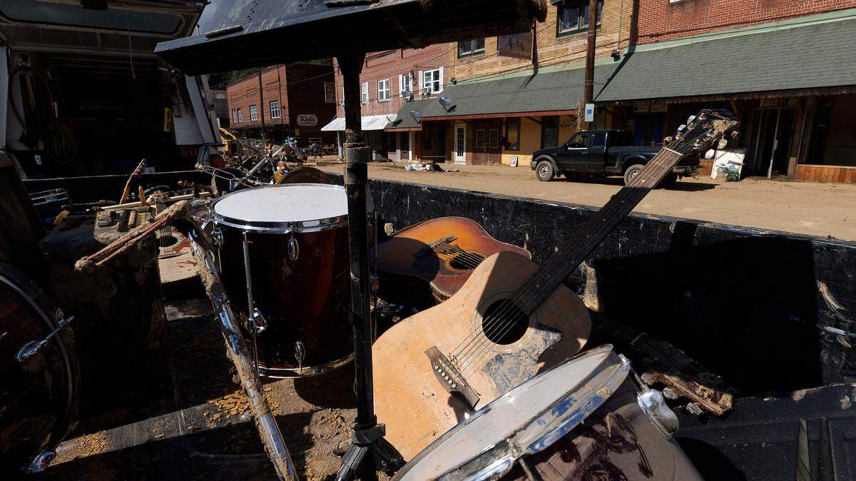 Mud-splattered instruments sit in the back of a truck as volunteers clear debris from Majestic Music in downtown Spruce Pine, N.C. on Thursday, Oct. 3, 2024, days after Hurricane Helene brought heavy flooding to the area.