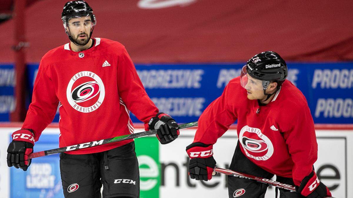 Carolina Hurricanes’ Cedric Paquette (18), left, and Max McCormick (28) confer during their practice at PNC Arena on Monday, May 24, 2021 in Raleigh, N.C.