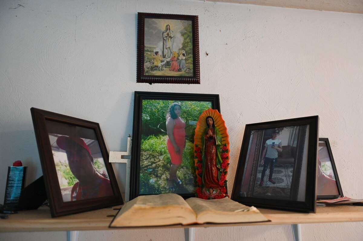 Inside his apartment, Fabian Ramirez keeps a small memorial altar to his parents and brother, who were killed in Petén, Guatemala, during a family land dispute two years ago.