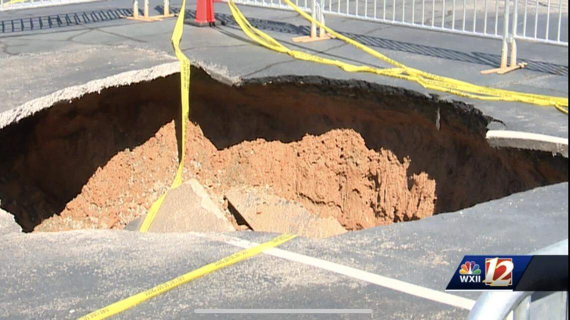 A woman fell about 10 feet into a sinkhole while at a North Carolina car dealership, she said.