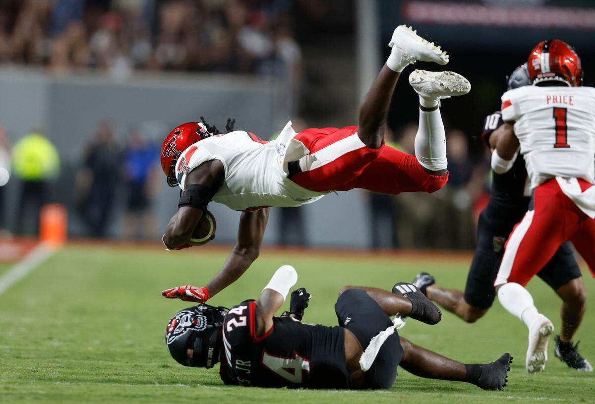 N.C. State cornerback Derrek Pitts Jr. (24) tackles Texas Tech running back SaRodorick Thompson (4) during the first half of N.C. States game against Texas Tech at Carter-Finley Stadium in Raleigh, N.C., Saturday, Sept. 17, 2022.