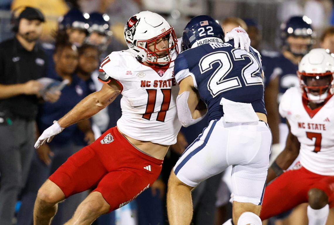 N.C. State linebacker Payton Wilson (11) wraps up Connecticut running back Victor Rosa (22) during the second half of N.C. State’s 24-14 victory over UConn at Rentschler Field in East Hartford, Conn. Thursday, August 31, 2023.
