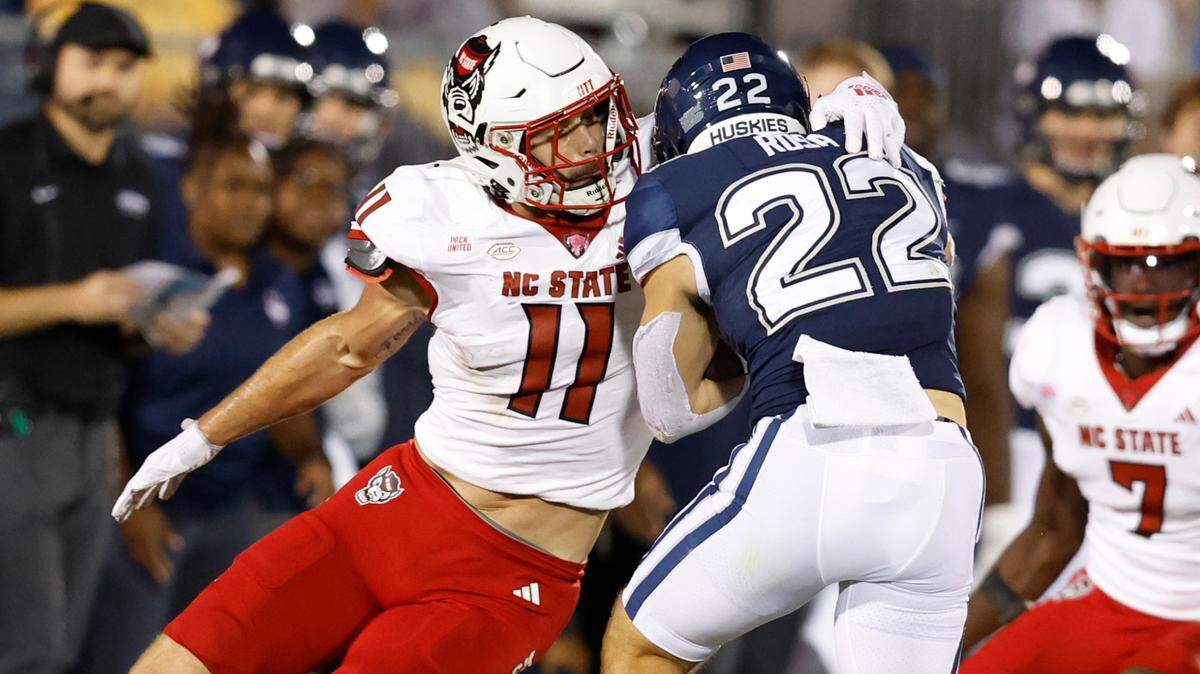 N.C. State linebacker Payton Wilson (11) wraps up Connecticut running back Victor Rosa (22) during the second half of N.C. State’s 24-14 victory over UConn at Rentschler Field in East Hartford, Conn. Thursday, August 31, 2023.