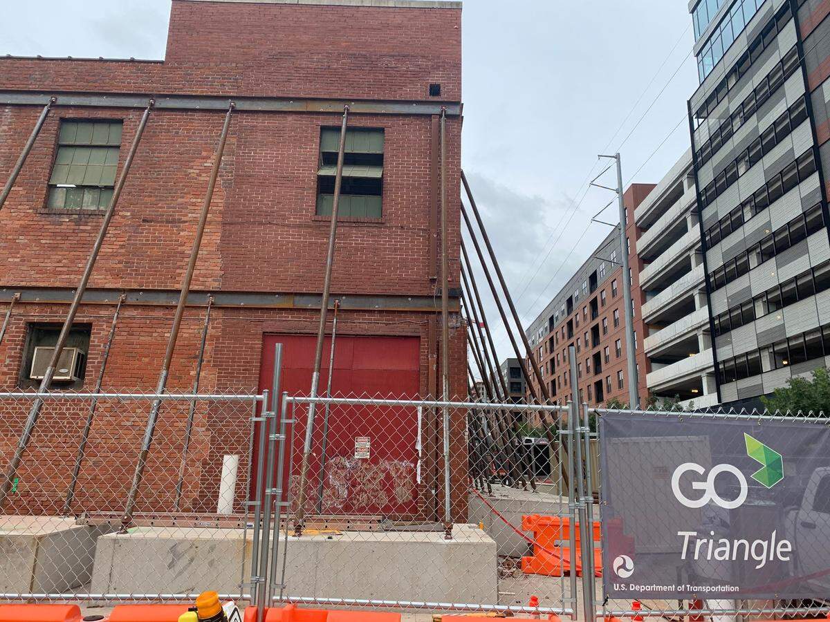 Workers have braced the walls of the former Dillon Supply Co. building on West Street in downtown Raleigh. The walls will be incorporated into Union West, a high-rise apartment complex being built next to Raleigh Union Station.