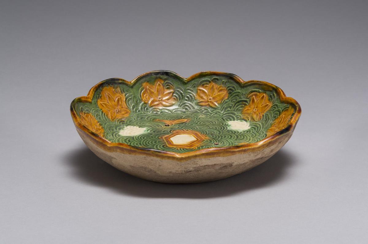 Unidentified artist, Chinese, Liao Dynasty (907-1125 CE): Sancai-Glazed Foliate Bowl, 10-11th century; pinkish buff earthenware with lead-fluxed clear, emerald-green, and caramel-brown glazes over a white-slip ground. Gift of Austin Scarlett and Smith Freeman in honor of the Museum’s 60th Anniversary.