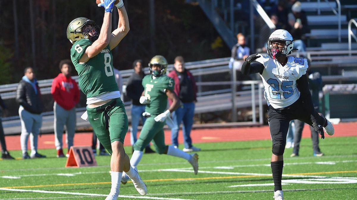 Cardinal Gibbons wide receiver Jake Taylor (8) makes the catch for the touchdown ahead of Panther Creek’s Kamari Mullen (25) during the first quarter. The Cardinal Gibbons Crusaders and the Panther Creek Catamounts met in the fourth round of the NCHSAA 4A playoffs in Raleigh, N.C. on November 26, 2021.