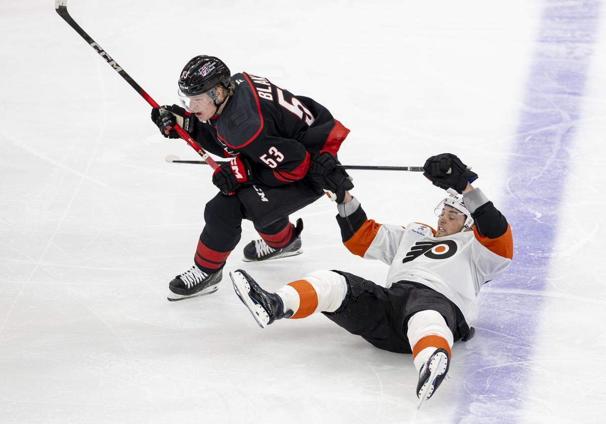Carolina Hurricanes right wing Jackson Blake (53) checks Philadelphia right wing Tyson Foerster (71) to the ice in the first period of Game 1 on Saturday, May 2, 2026, during the second round of the Stanley Cup Playoffs at Lenovo Center in Raleigh, N.C.