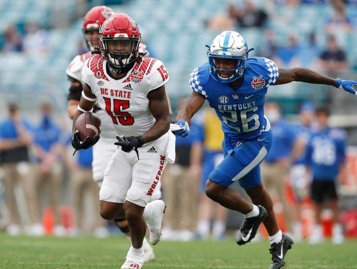 Kentucky defensive back Brandin Echols (26) tries to slow down N.C. State wide receiver Keyon Lesane (15) during the second half of Kentucky’s 23-21 victory over N.C. State in the Gator Bowl at TIAA Bank Field in Jacksonville, Fla., Saturday, January 2, 2021.