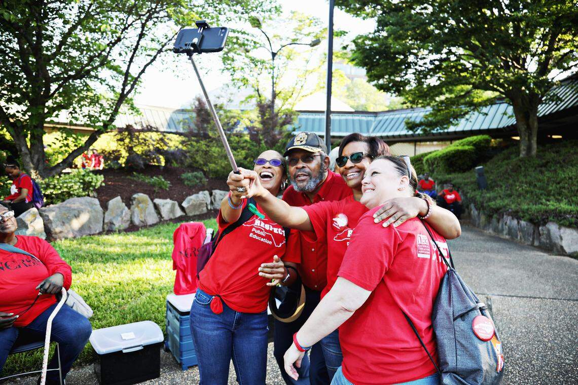 From left, Shannon Daniels, Willie Ramey, Dee Grisset and Amy Harrison take a selfie in the parking lot of The N.C. Association of Educators in downtown Raleigh before the start of the teacher’s march and rally, Tuesday, May 1, 2019.