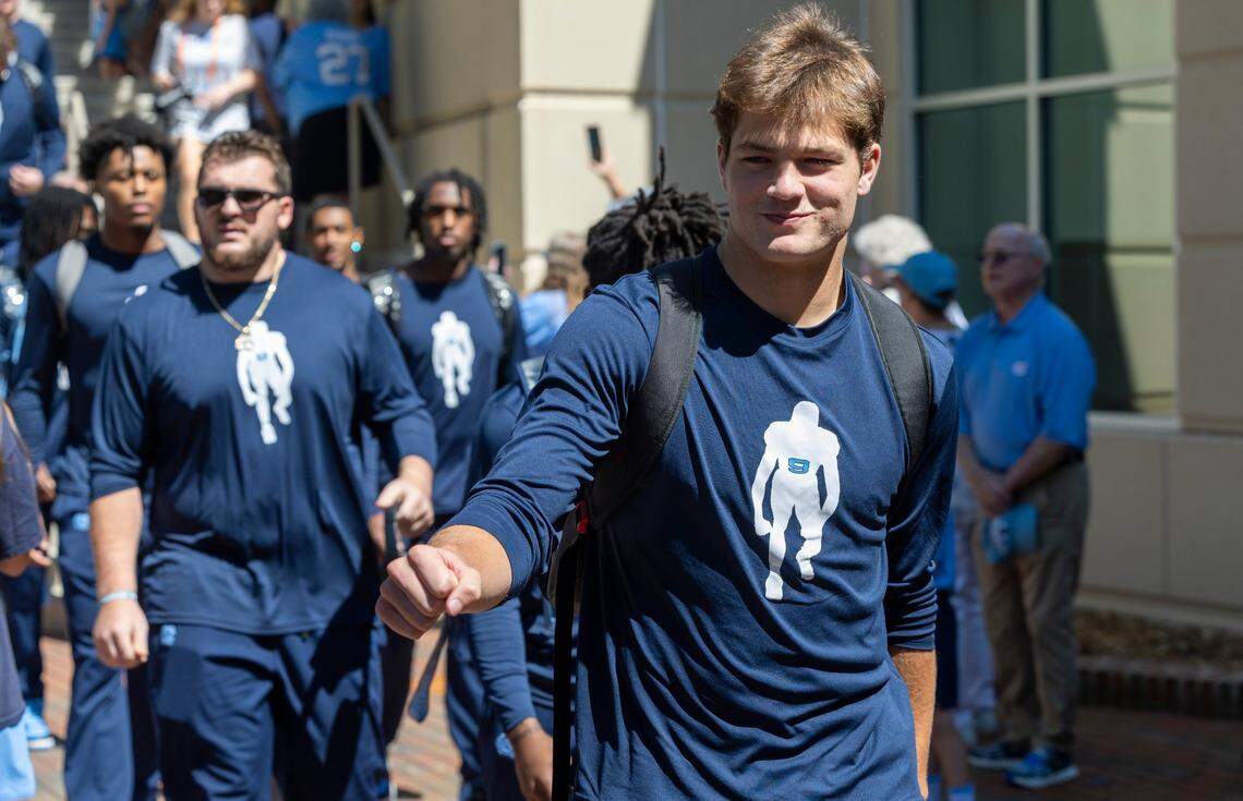 North Carolina quarterback Drake Maye (10) and his teammates show their support for teammate Devontez Walker, wearing shirts with his likeness on the front and his name across their backs, as they walk from the Bell Tower to Kenan Stadium for their game against Minnesota on Saturday, September 16, 2023 at Kenan Stadium in Chapel Hill N.C. The NCAA announced earlier this month that Walker, a transfer to UNC from Kent State, wouldn’t be granted eligibility for the 2023 season.