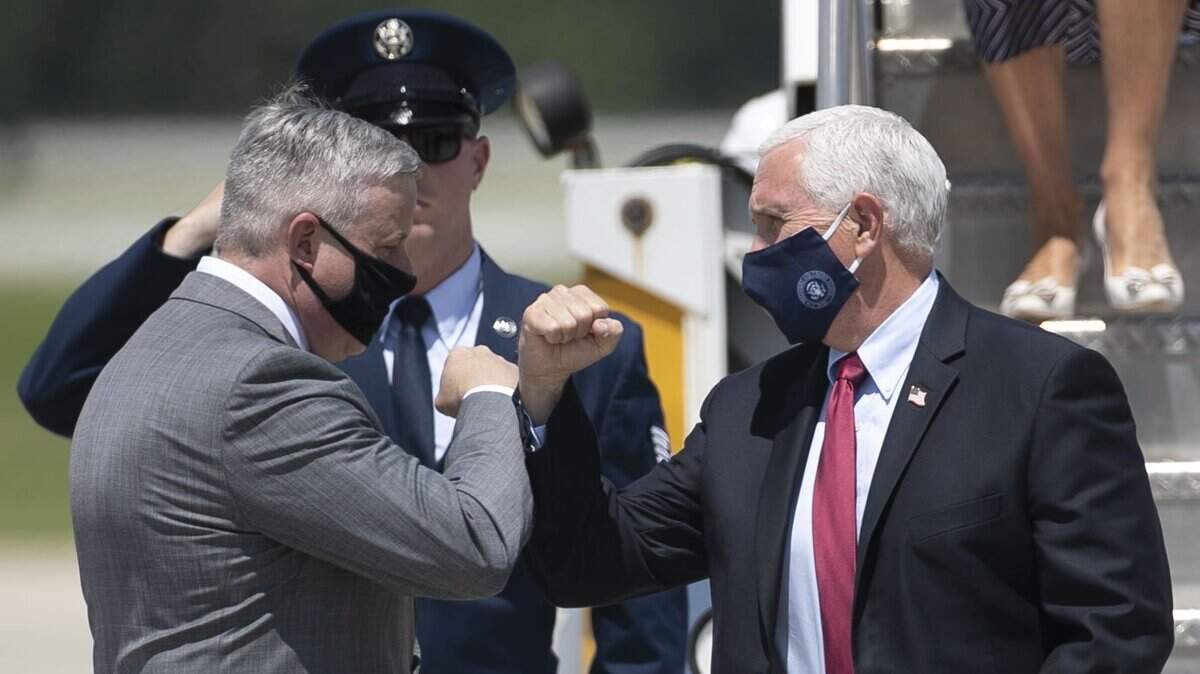 NC GOP chairman Michael Whatley, greets Vice President Pence, and travel companions at Raleigh-Durham International Airport on Wednesday, July 29, 2020 in Morrisville, N.C. 