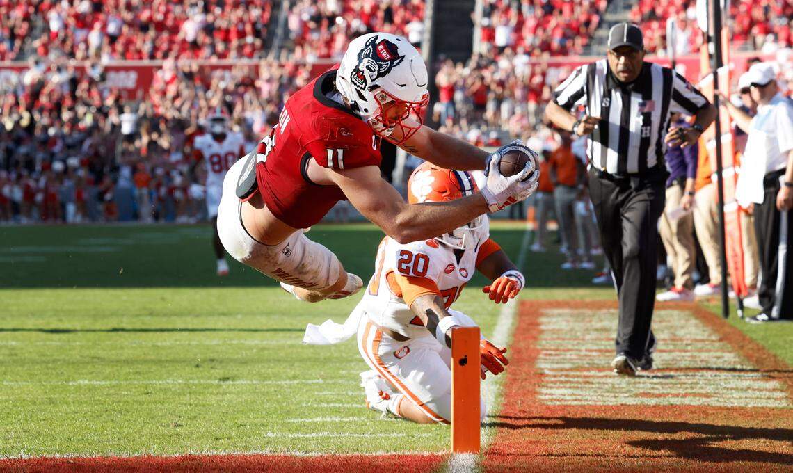 N.C. State linebacker Payton Wilson (11) dives in to score on a 15-yard touchdown interception during the second half of N.C. State’s 24-17 victory over Clemson at Carter-Finley Stadium in Raleigh, N.C., Saturday, Oct. 28, 2023.