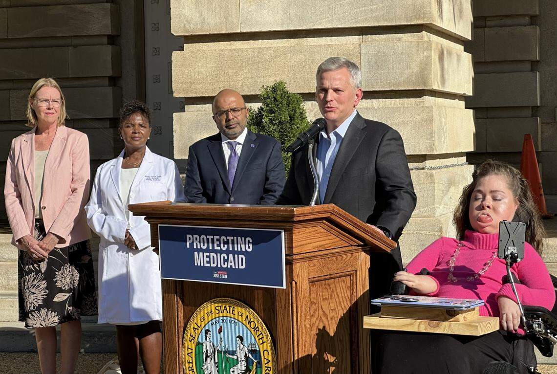 From left, Betsy MacMichael, Dr. Karen Smith, N.C. Health and Human Services Secretary Devdutta Sangvai, Gov. Josh Stein and Demi Eckhoff speak outside the State Capitol on Thursday, calling for action to reverse Medicaid cuts.