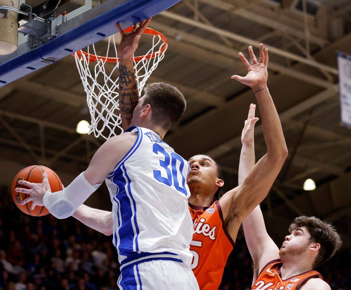 Duke’s Kyle Filipowski drives to the basket around Virginia Tech’s Lynn Kidd and Grant Basile during the second half of the Blue Devils’ 81-65 win over Virginia Tech on Saturday, Feb. 25, 2023, at Cameron Indoor Stadium in Durham, N.C.