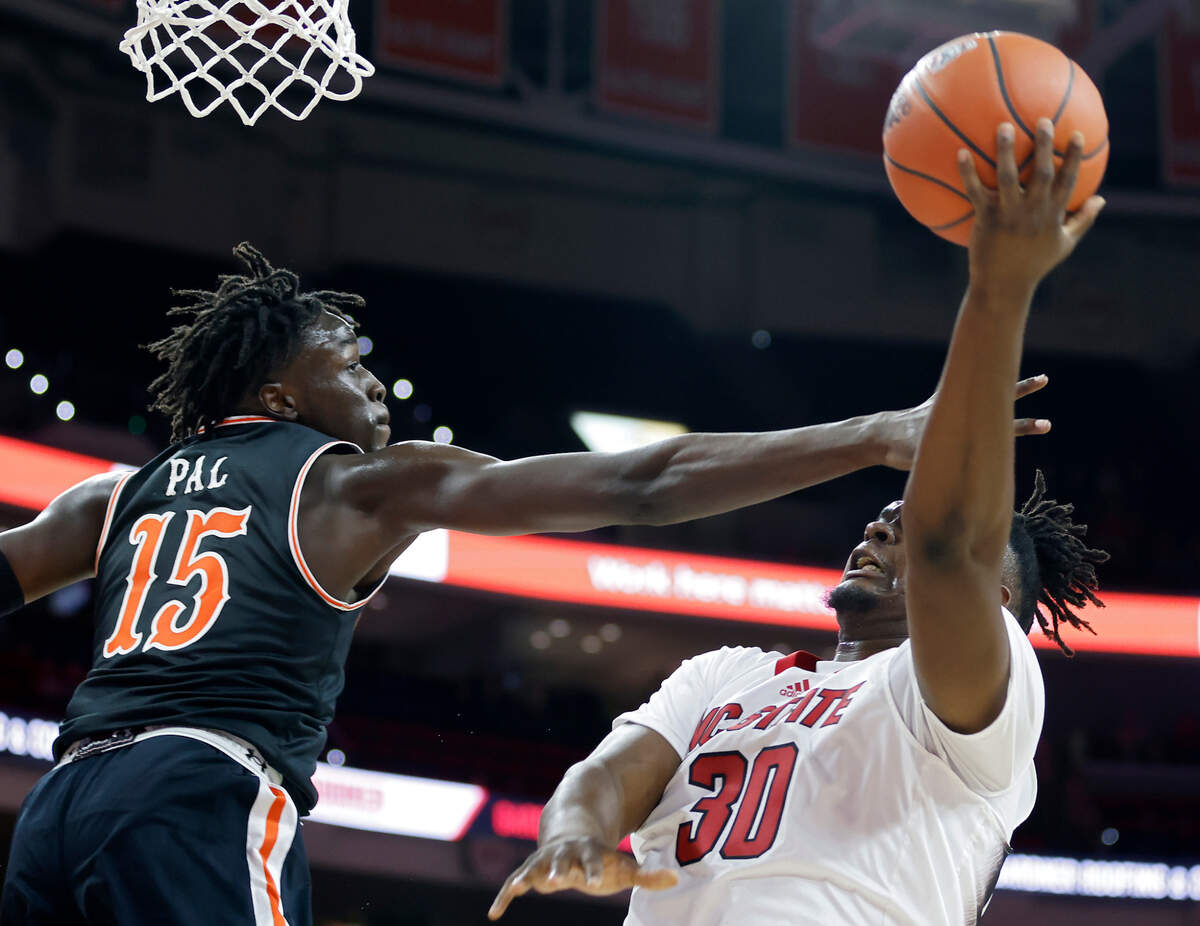 North Carolina State Wolfpack forward D.J. Burns Jr. shoots over Campbell Fighting Camels forward Jay Pal during the first half of a men’s basketball game at PNC Arena in Raleigh, N.C. on Friday, Nov. 11, 2022.