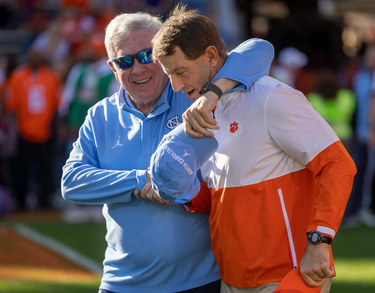 North Carolina coach Mack Brown embraces Clemson coach Dabo Swinney prior to their game on Saturday, November 18, 2023 at Memorial Stadium in Clemson, S.C.