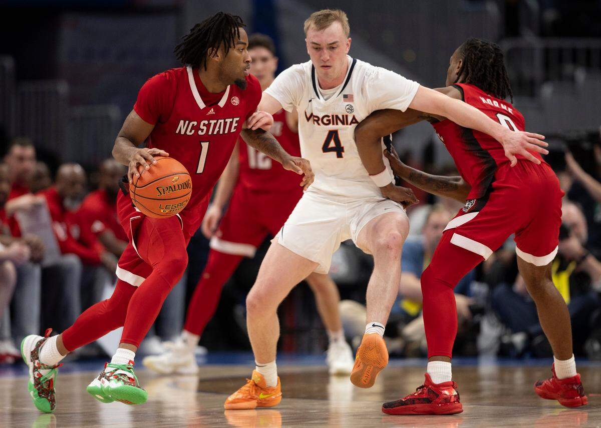 N.C. State’s D.J. Horne (0) sets a screen on Virginia’s Andrew Rohde (4) for teammate Dante Harris (1) in the second half during the semi-finals of the ACC Men’s Basketball Tournament at Capitol One Arena on Friday, March 15, 2024 in Washington, D.C.