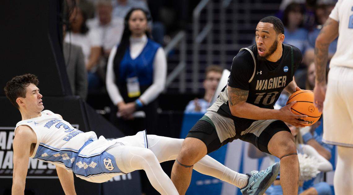 Wagner’s Tahron Allen (10) is called for charging after a collision with North Carolina’s Cormac Ryan (3) in the first half on Thursday, March 21, 2024 during the NCAA Tournament at Spectrum Center in Charlotte, N.C.