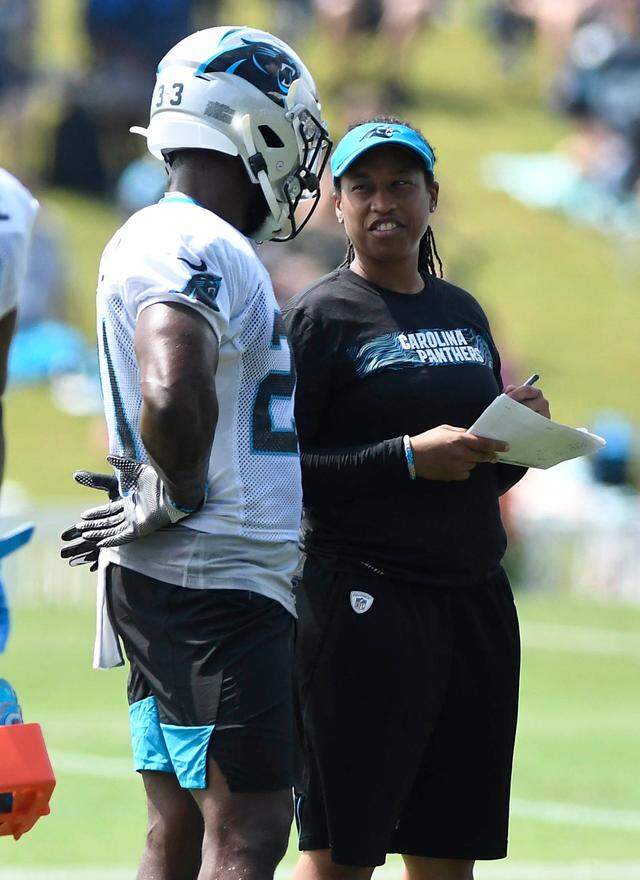 Carolina Panthers coaching intern Jennifer King talks with running back Elijah Holyfield (21) during training camp at Wofford College August 4, 2019. In 2021, she was named Washington Football Team’s assistant running backs coach.&nbsp;