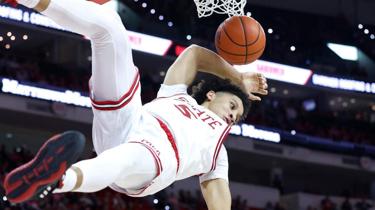 N.C. State’s Jack Clark (5) goes down after putting in two during the second half of N.C. State’s game against Wake Forest at PNC Arena in Raleigh, N.C., Wednesday, Feb. 22, 2023.