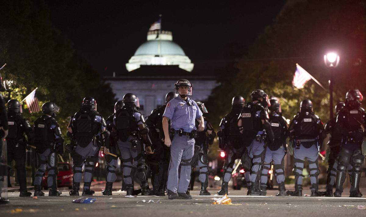 Raleigh Police block Fayetteville Street at Hargett Street as they work to return order after a night of violent demonstrations early Sunday morning May 31, 2020 in Raleigh, N.C.