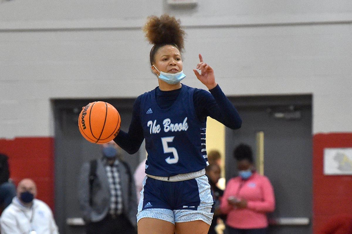 Milbrook’s Reychel Douglas (5) calls out a play to her team during the first half. The Wake Forest Cougars and the Millbrook Wildcats met in a basketball game in Wake Forest, N.C. on February 8, 2022.