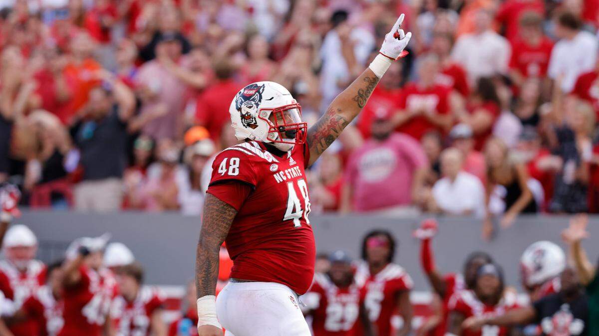 N.C. State defensive tackle Cory Durden (48) celebrates after making a stop during the first half of N.C. State’s game against Clemson at Carter-Finley Stadium in Raleigh, N.C., Saturday, Sept. 25, 2021.