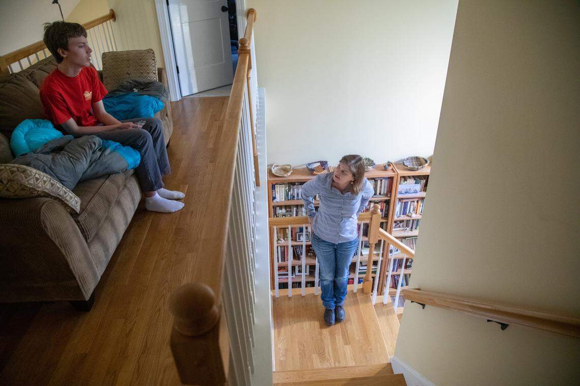 In this Feb. 11, 2020 photo, Laura Branan tries to convince her son Joe Branan, 18, to walk with her in their Chapel Hill neighborhood. Joe was diagnosed with autism at age 2 and at the time his parents had been on the waitlist for a Medicaid program offering home and community based services to people with disabilities for 16 years. 