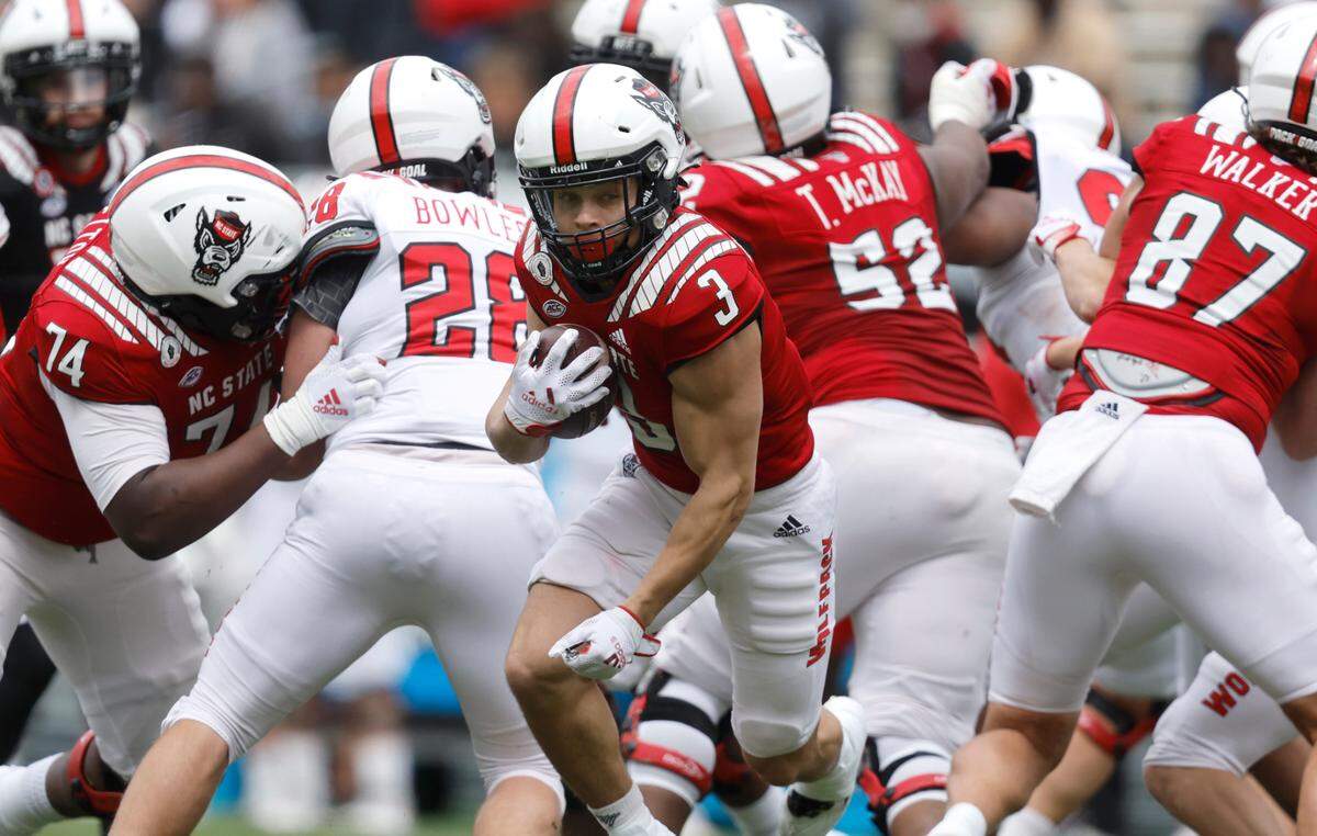 N.C. State running back Jordan Houston (3) gains yards during N.C. State football’s spring game at Carter-Finley Stadium in Raleigh, N.C., Saturday, April 9, 2022.
