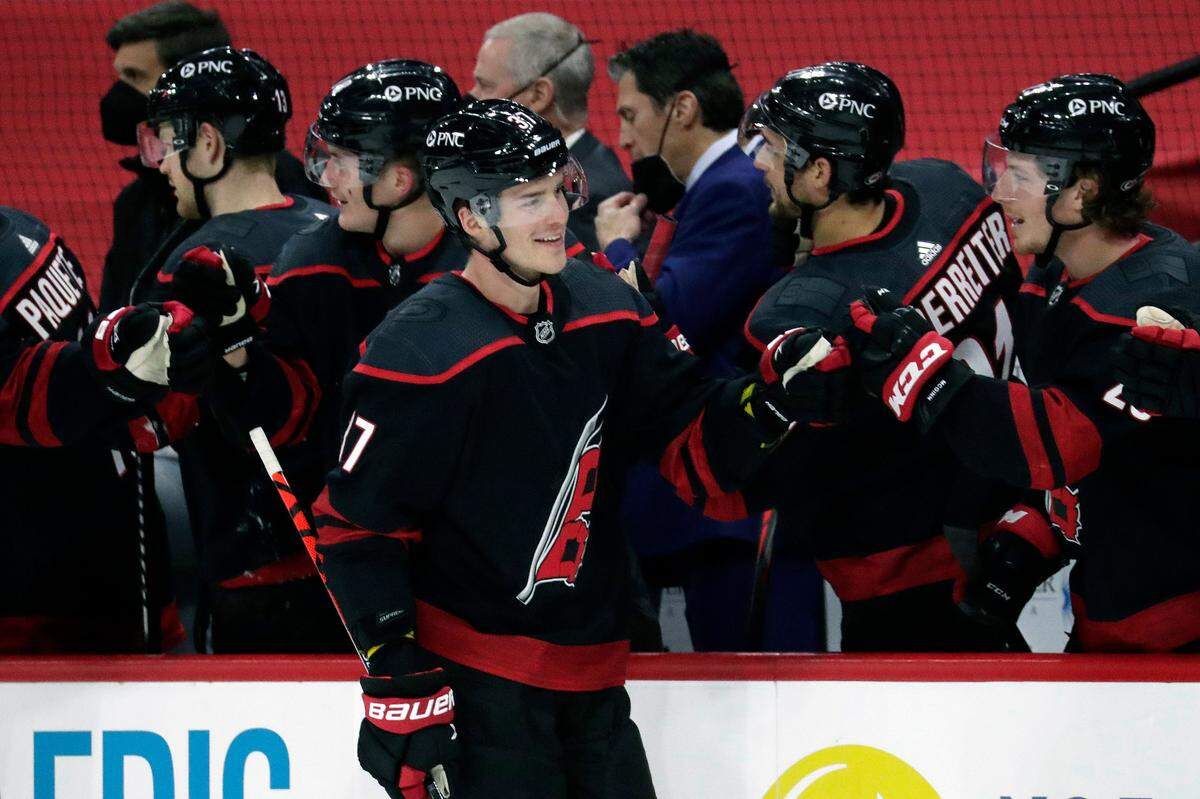 The Carolina Hurricanes’ Andrei Svechnikov (37) celebrates his power-play goal with teammates during the first period of an NHL hockey game against the Detroit Red Wings in Raleigh, N.C., Thursday, March 4, 2021. AP Photo/Chris Seward)