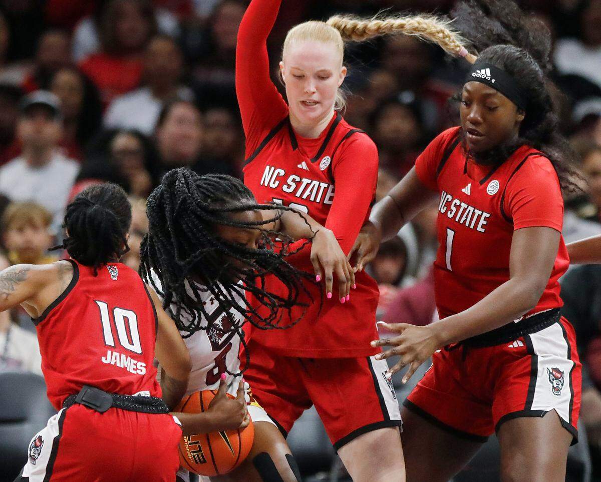 N.C. State’s Aziaha James, Tilda Trygger and Lorena Awou swarm South Carolina’s Joyce Edwards during the second half of the Wolfpack’s 71-57 loss on Sunday, Nov. 10, 2024, at Spectrum Center in Charlotte, N.C.