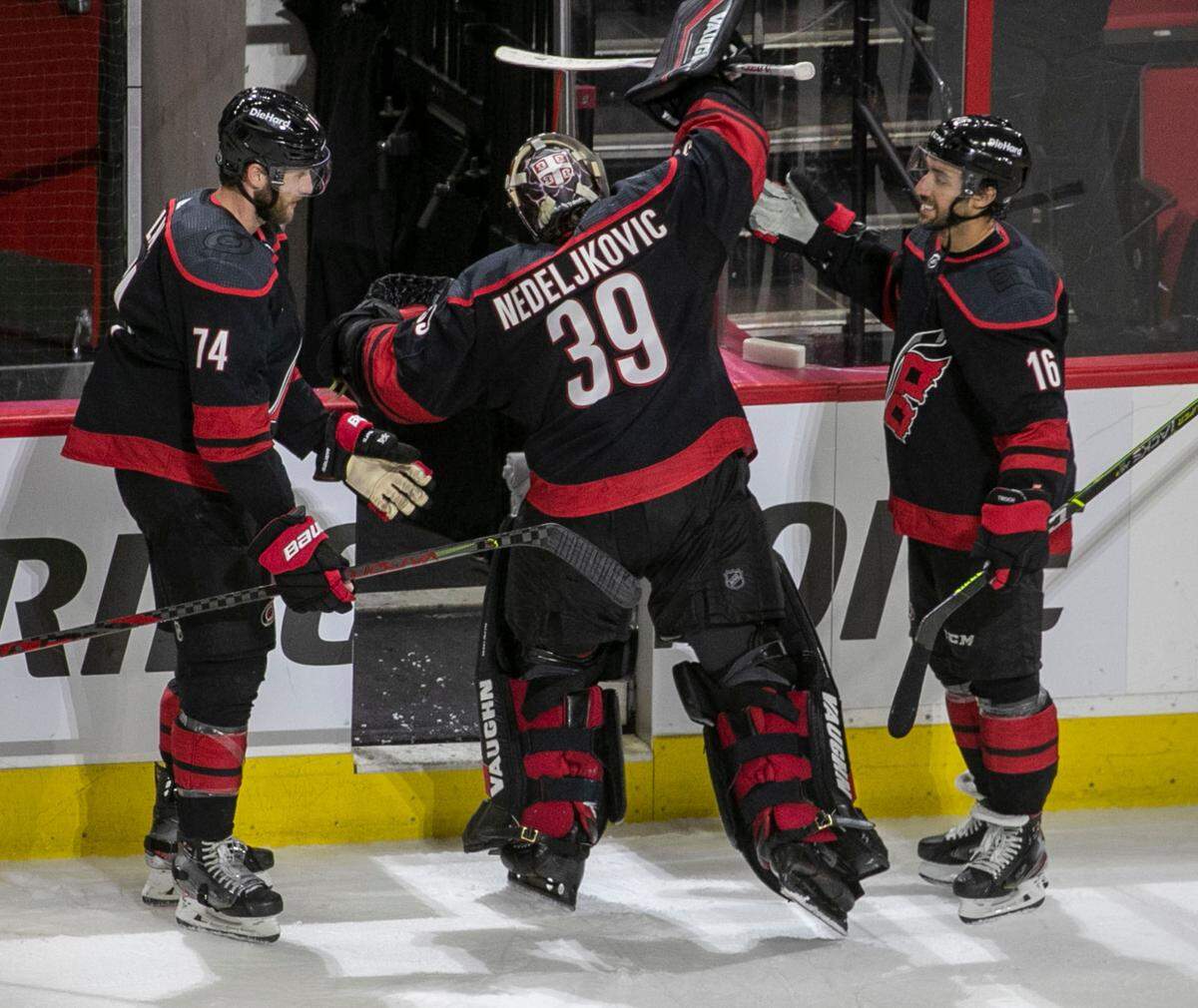 Carolina Hurricanes’ Jaccob Slavin (74), goalie Alex Nedeljkovic (39) and Vincent Trocheck (16) the last to leave the ice following their 5-2 victory over Nashville on Monday, May 17, 2021 at PNC Arena in Raleigh, N.C.