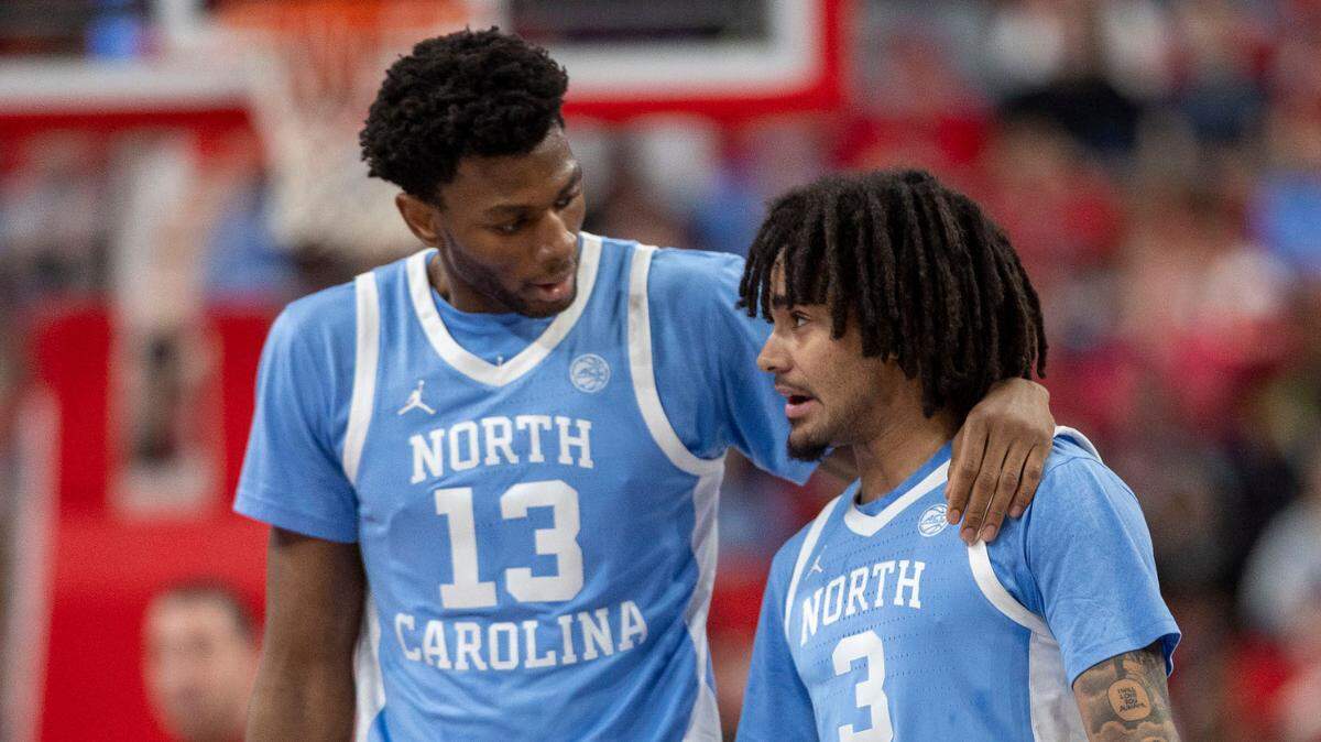 North Carolina guard Elliot Cadeau (3) confers with teammate Jalen Washington (13) in the first half against N.C. State on Saturday, January 11, 2025 at Lenovo Center in Raleigh, N.C.