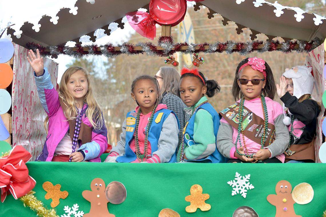 Members of Girl Scout Troop 4824 ride in the float and wave to the crowd in the Garner Christmas Parade in 2016.