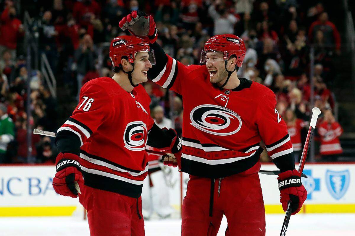 Carolina Hurricanes’ Brady Skjei (76) is congratulated on his goal by teammate Brett Pesce (22) during the second period of an NHL hockey game against the Florida Panthers in Raleigh, N.C., Saturday, Jan. 8, 2022. (AP Photo/Karl B DeBlaker)