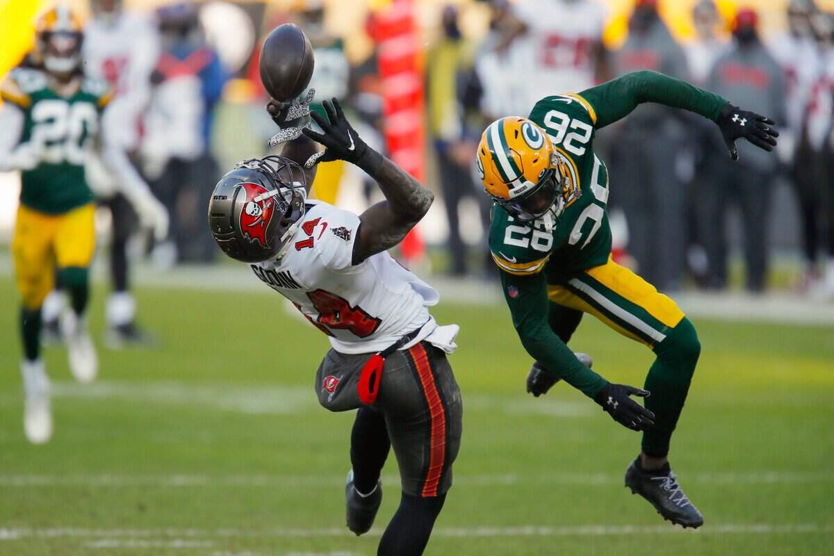 Tampa Bay Buccaneers’ Chris Godwin (14) catches a pass against Green Bay Packers’ Darnell Savage (26) during the first half of the NFC championship NFL football game in Green Bay, Wis., Sunday, Jan. 24, 2021.