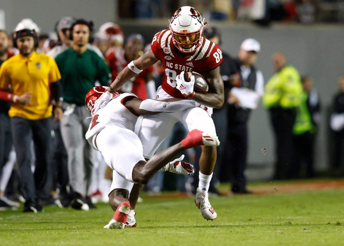 N.C. State wide receiver Devin Carter (88) tries to get around Louisville defensive back Chandler Jones (2) during the first half of N.C. States game against Louisville at Carter-Finley Stadium in Raleigh, N.C., Saturday, October 30, 2021.