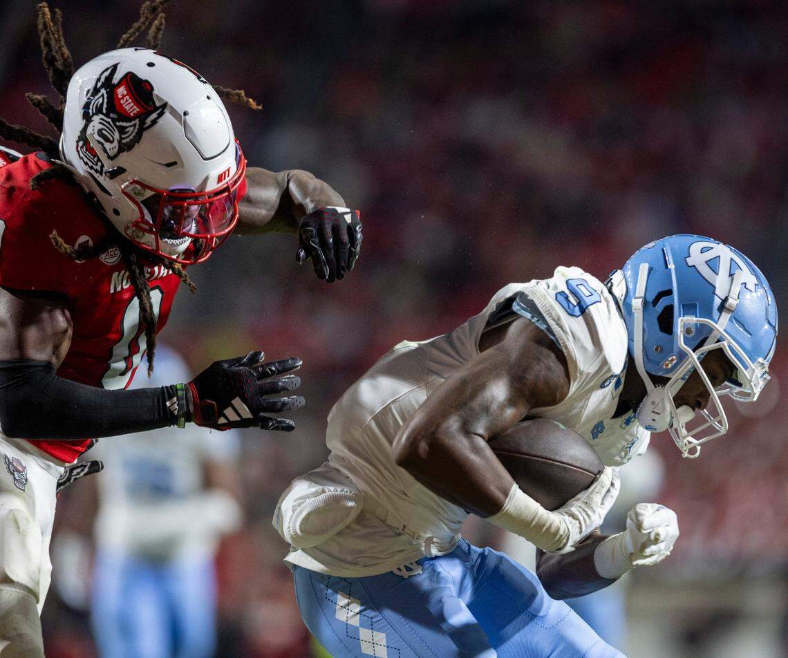 North Carolina’s Devontez Walker (9) scores on a 21-yard pass completion from quarterback Drake Maye in the third quarter against N.C. State on Saturday, November 25, 2023 at Carter-Finley Stadium in Raleigh, N.C.