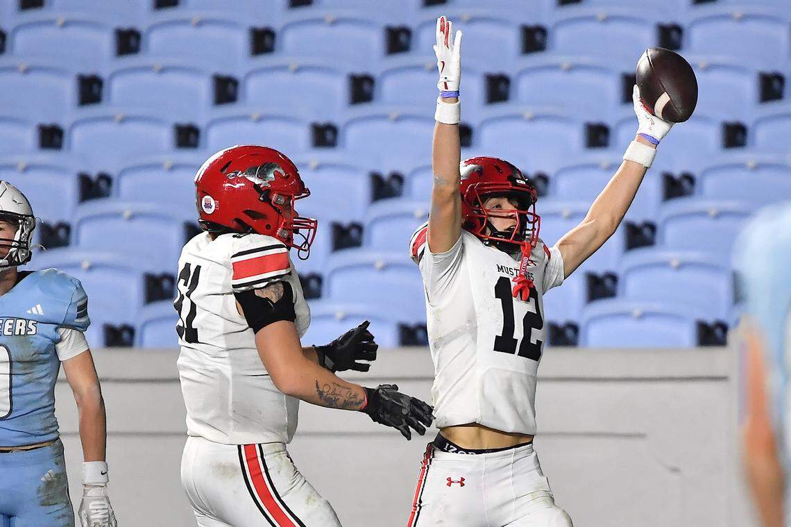 Middle Creek wide receiver Nicolas Bocciardi (12) celebrates his touchdown against Watauga with Sean Clementson (61) during the second half. The Middle Creek Mustangs and the Watauga Pioneers met in the NCHSAA 6A Football Championship game in Chapel Hill, N.C. on December 12, 2025. 