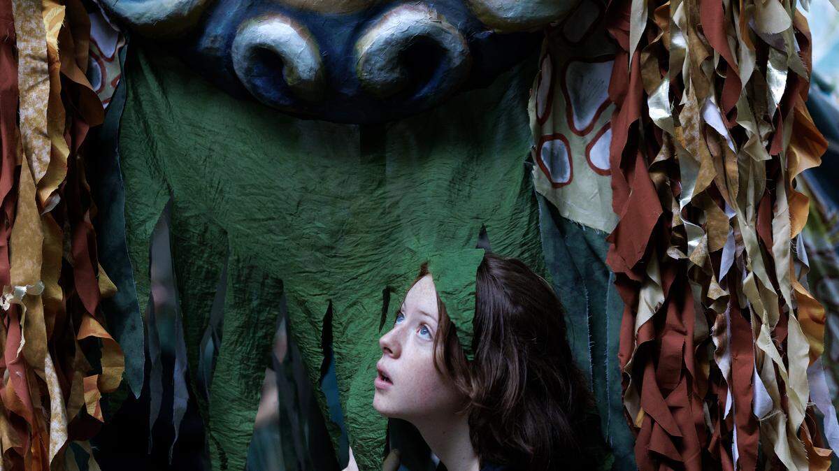 Althea Clayton, a puppeteer with Paperhand Puppet Intervention, looks out from a river puppet during a rehearsal for the organization’s show, “The Gift,” on Tuesday, Aug. 12, 2025, at the Forest Theatre in Chapel Hill, N.C. 