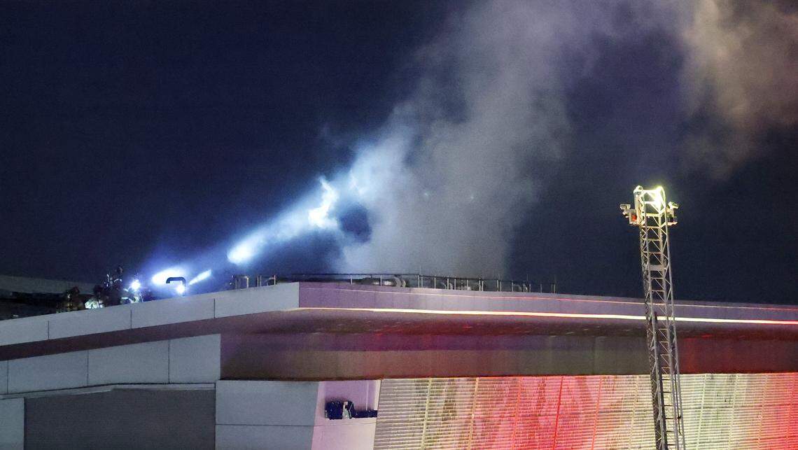 Firefighters work on the roof at the Raleigh Convention Center in downtown Raleigh, N.C., Monday evening, Dec. 1, 2025.