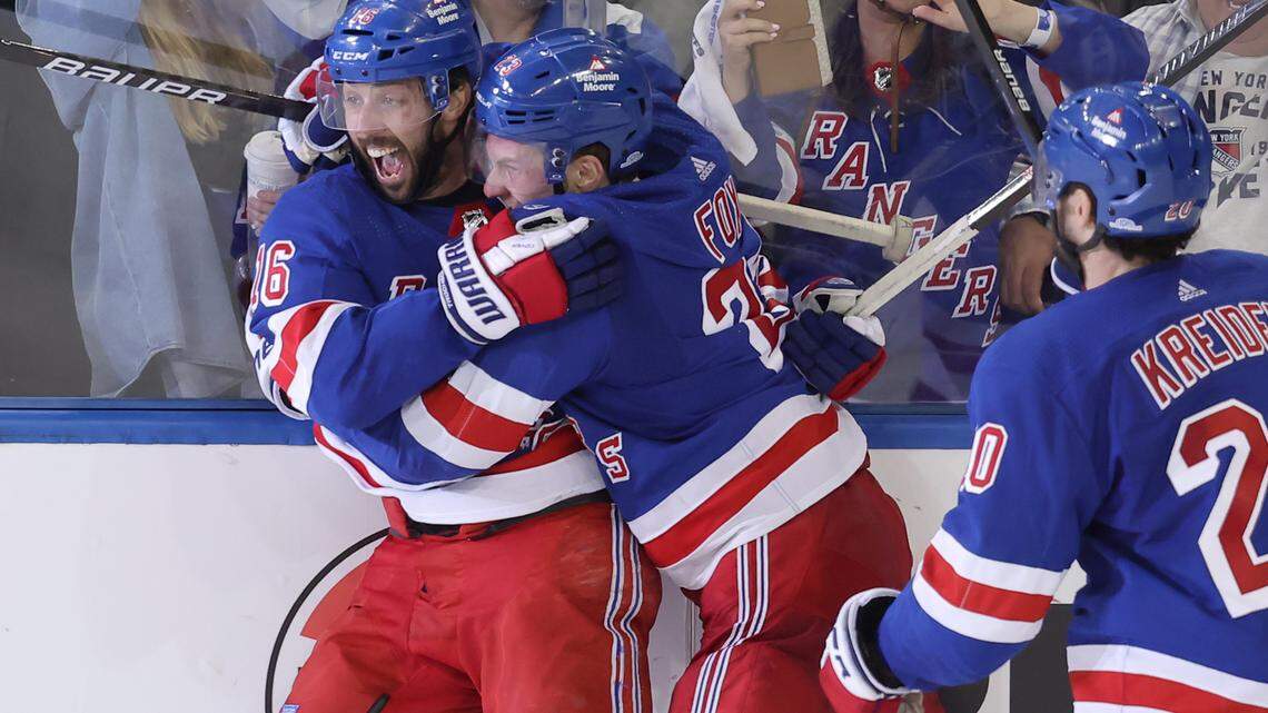 New York Rangers center Vincent Trocheck (16) celebrates his game winning goal against the Carolina Hurricanes with defenseman Adam Fox (23) and left wing Chris Kreider (20) during the second overtime of game two of the second round of the 2024 Stanley Cup Playoffs at Madison Square Garden.