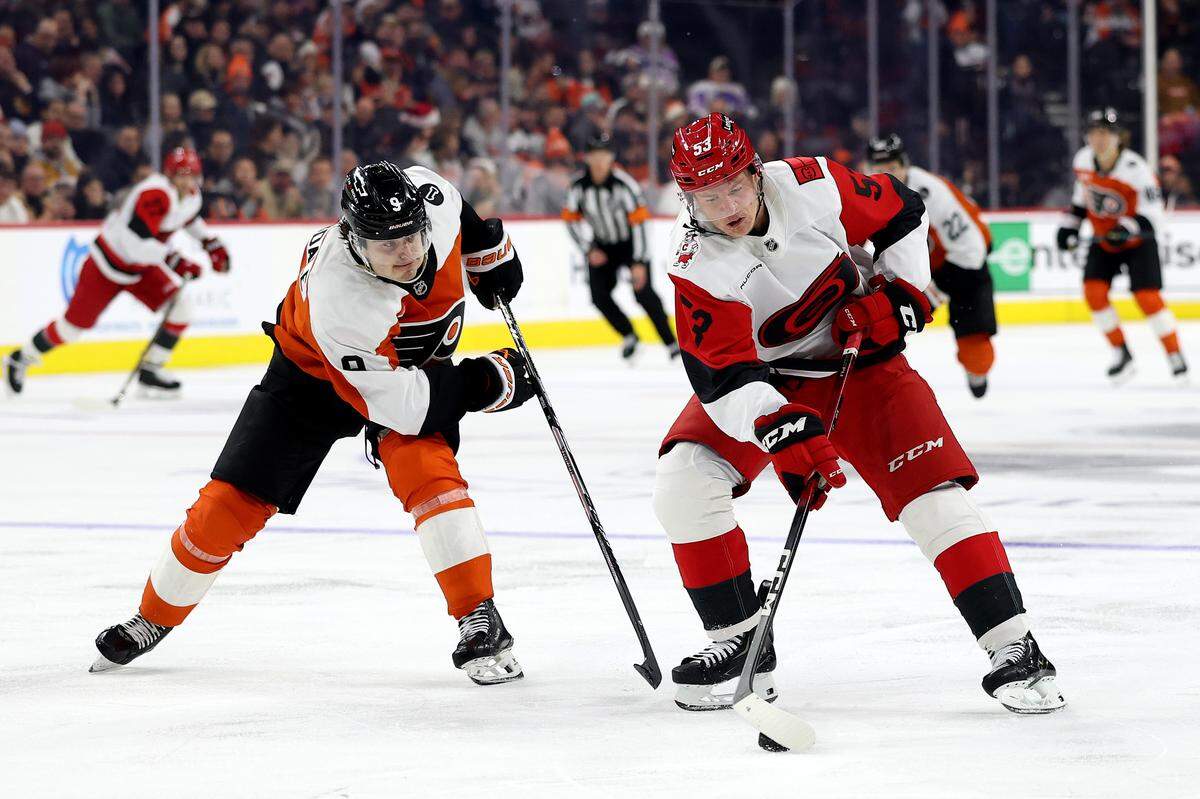 Jackson Blake (53) of the Carolina Hurricanes controls the puck against Jamie Drysdale of the Philadelphia Flyers during the third period at Xfinity Mobile Arena on Dec. 13, 2025 in Philadelphia, Pennsylvania.
