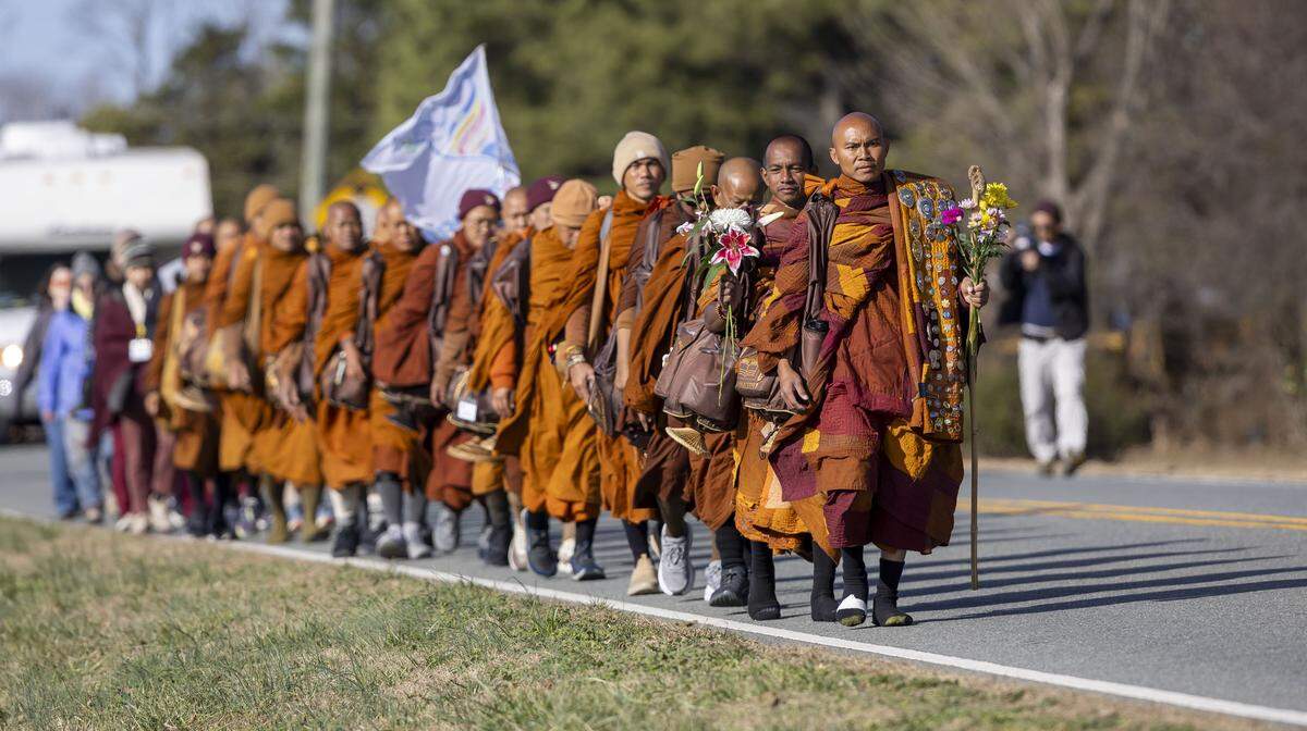 Buddhist monks walk along South Greensboro Street during the Walk for Peace on Wednesday, Jan. 21, 2026 in Liberty, N.C.