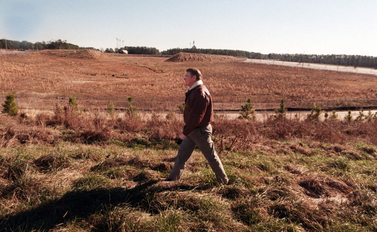 Steve Stroud walks by the area that has been excavated for the new arena near Carter Finley Stadium in 1996.