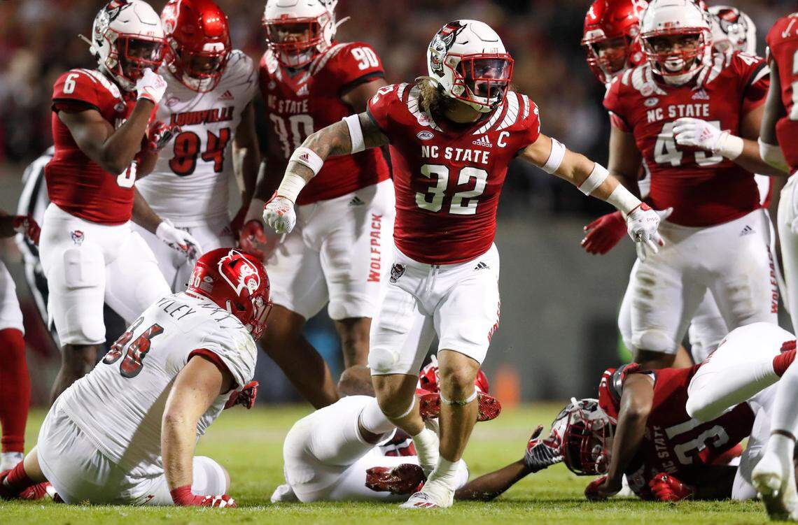 N.C. State linebacker Drake Thomas (32) celebrates after stopping Louisville running back Jalen Mitchell (15) during the first half of N.C. State’s game against Louisville at Carter-Finley Stadium in Raleigh, N.C., Saturday, October 30, 2021.