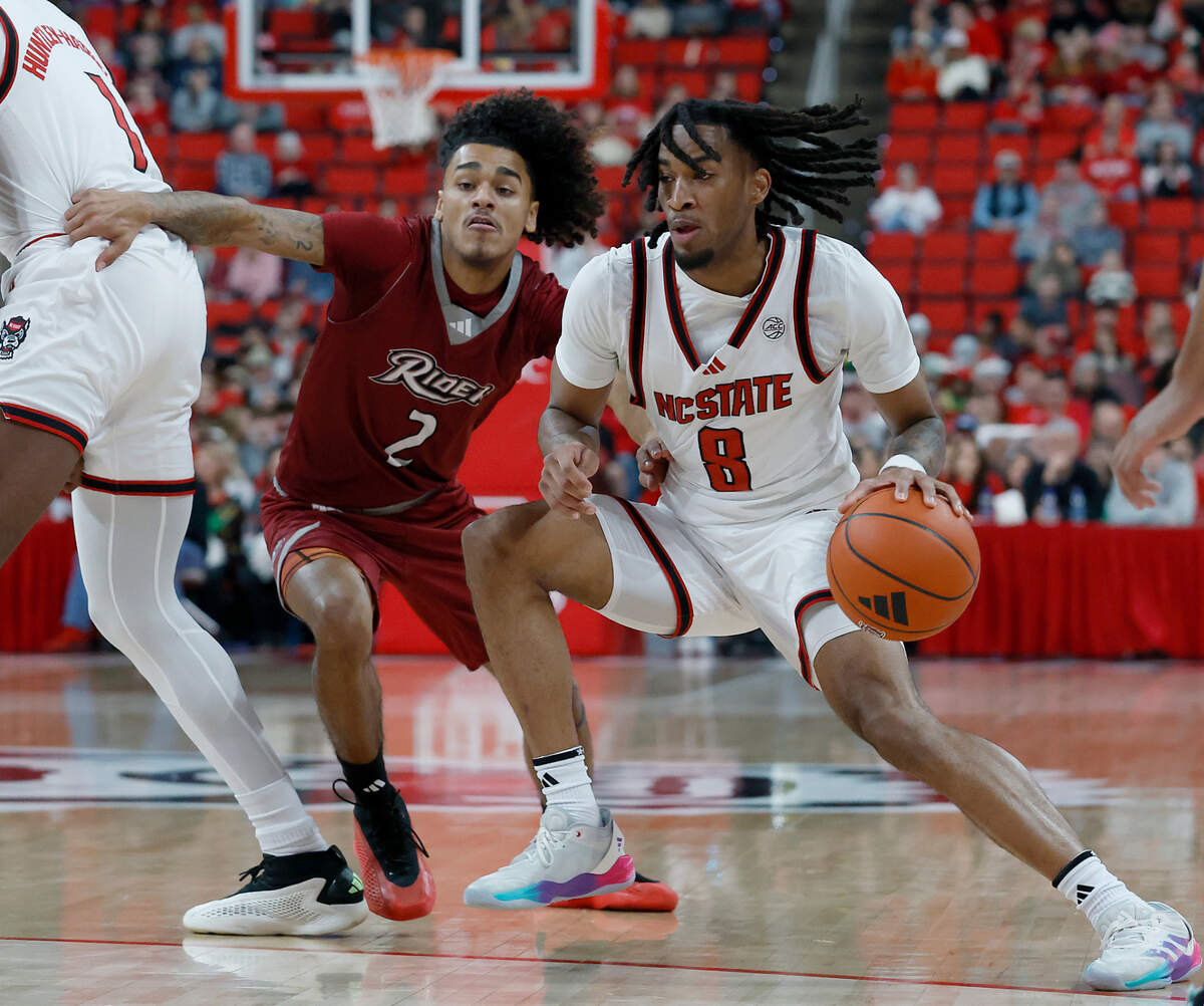 N.C. State’s Jayden Taylor drives past Rider’s Ruben Rodriguez during the first half of the Wolfpack’s 89-63 win on Sunday, Dec. 22, 2024, at Lenovo Center in Raleigh, N.C.