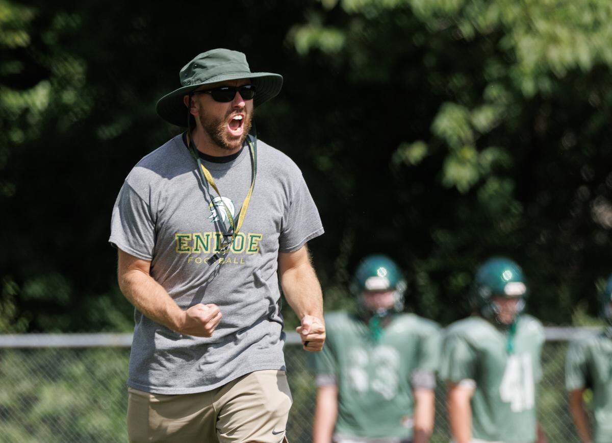 Enloe High School football coach Ryan Clark talks with his team during practice on Monday, Aug. 18, 2025, in Raleigh, N.C.