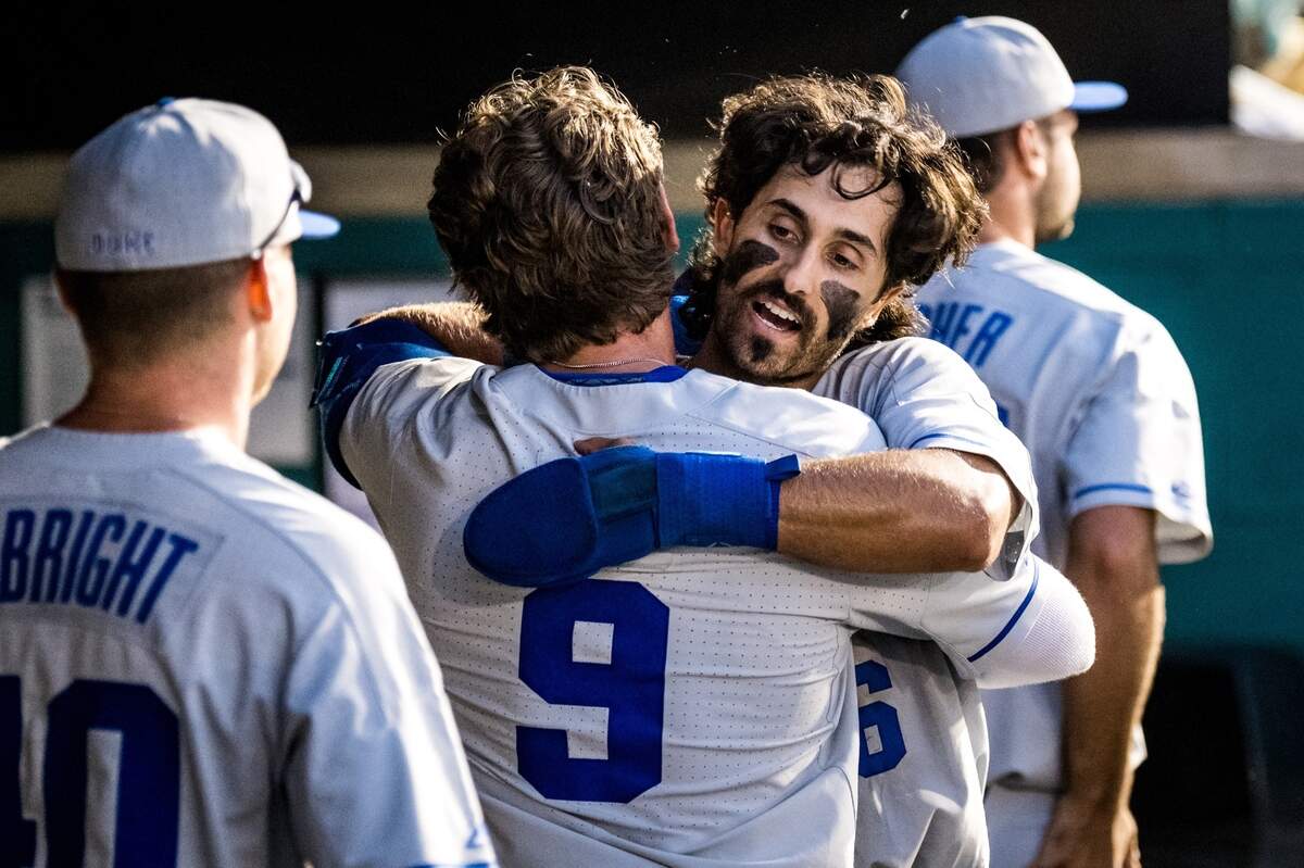 Duke’s Gio DiGiacomo hugs teammate Damon Lux (9) after Lux’s sacrifice fly drove in DiGiacomo with the go-ahead run in the ninth inning of the Blue Devils’ 2-1 win over the Rider Broncs Saturday night in the NCAA Tournament Conway Regional at Springs Brooks Stadium in Conway, S.C.