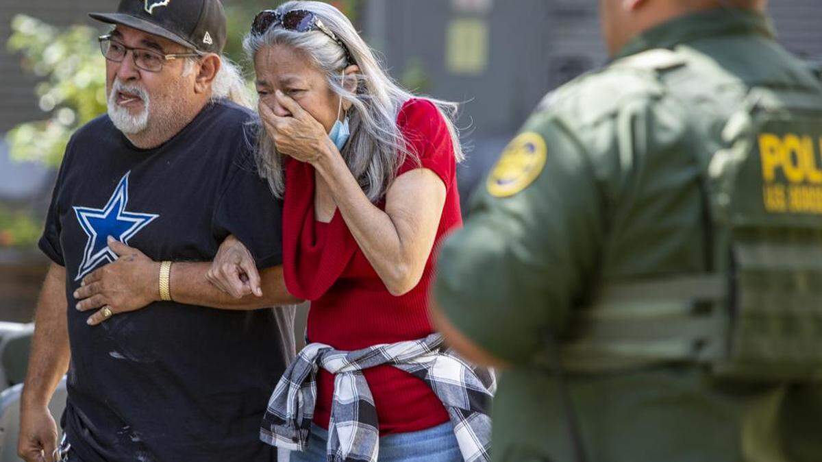 A woman cries as she leaves the Uvalde Civic Center on May 24, 2022 in Uvalde, Texas where 19 students and two teachers were killed in a mass shooting at a South Texas elementary school. The 18-year-old gunman also died.